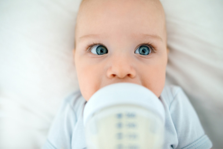 Baby drinking from a bottle.