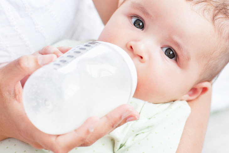 Baby drinking from a bottle.