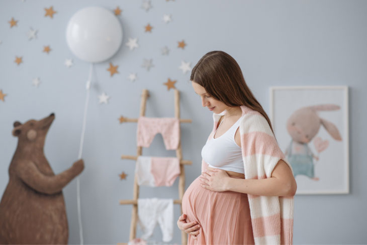 A pregnant woman in a baby nursery.